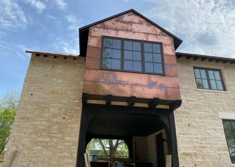 Copper metal panel facade on a stone building for Skylight Installation in Helena Valley Northwest